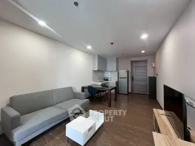 Modern living room with sleek furniture and open kitchen layout