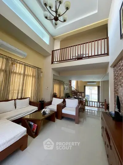 Spacious living room with high ceiling and elegant decor