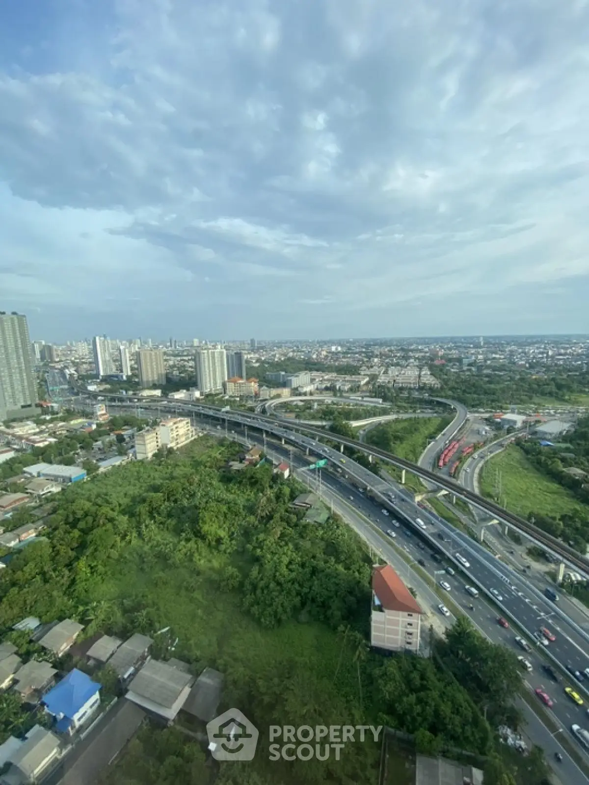 Stunning cityscape view with highways and lush greenery, perfect for urban living enthusiasts.