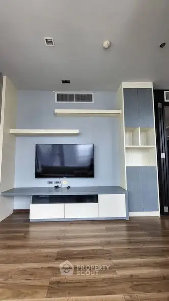 Modern living room with sleek TV unit and wooden flooring
