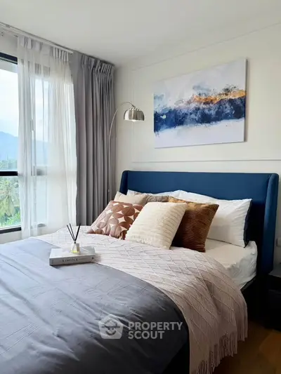 Cozy bedroom with elegant decor and large window view