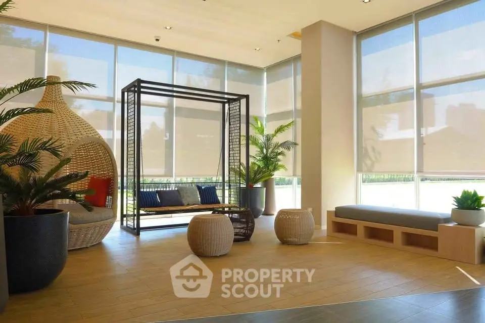 Modern lobby with stylish seating and large windows in a contemporary building.