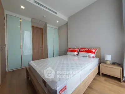 Modern bedroom with wooden flooring and minimalist design