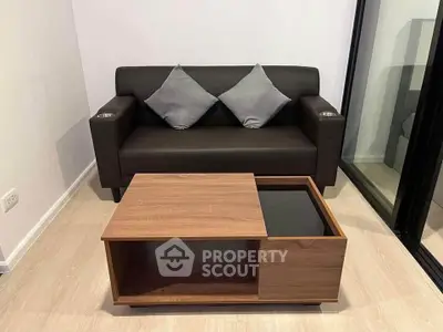 Modern living room with sleek black sofa and stylish wooden coffee table