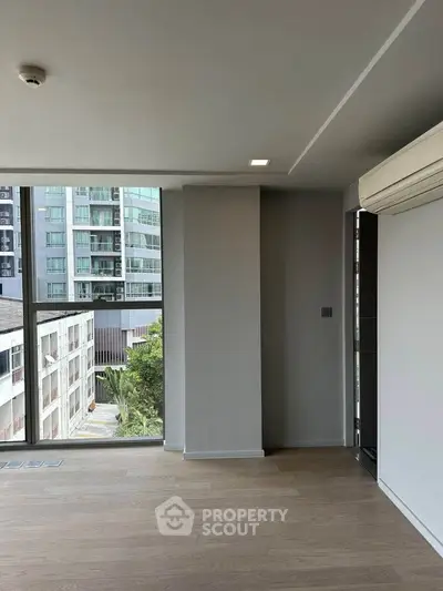 Modern apartment interior with large windows and city view