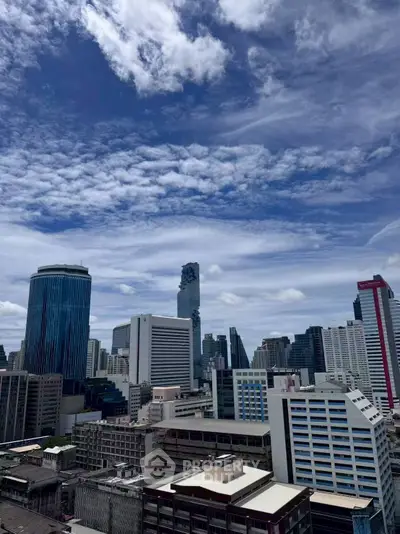 Stunning cityscape view showcasing modern skyscrapers under a vibrant blue sky, perfect for urban living enthusiasts.