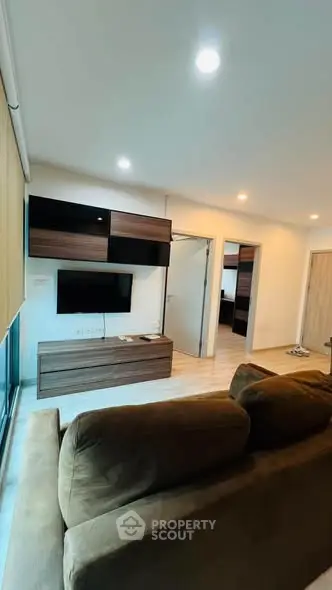 Modern living room with sleek furniture and ambient lighting in a stylish apartment.