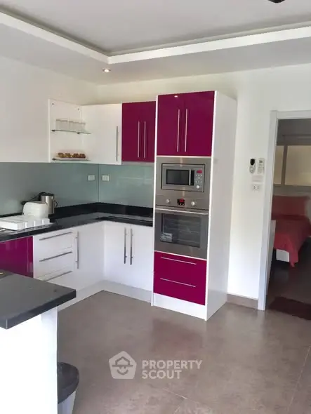 Modern kitchen with sleek cabinetry and built-in appliances in a stylish apartment.