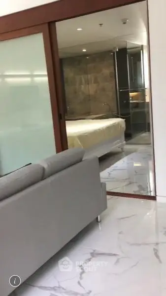 Modern apartment interior with sliding glass doors and marble flooring