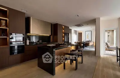 Luxurious modern kitchen with open layout and dining area, featuring sleek cabinetry and high-end appliances.