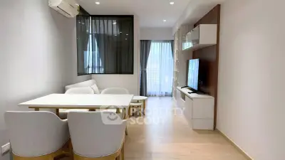 Modern living room with sleek furniture and natural light, perfect for relaxation and entertainment.