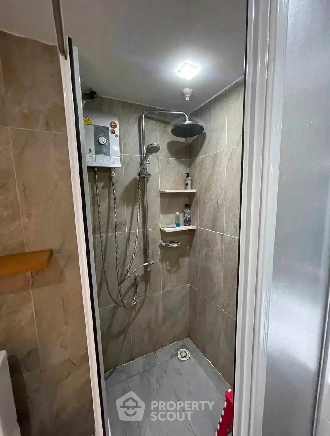 Modern bathroom with sleek shower and tiled walls in a contemporary home.