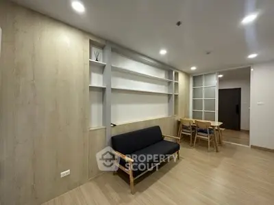 Modern living room with sleek wooden flooring and minimalist furniture design.