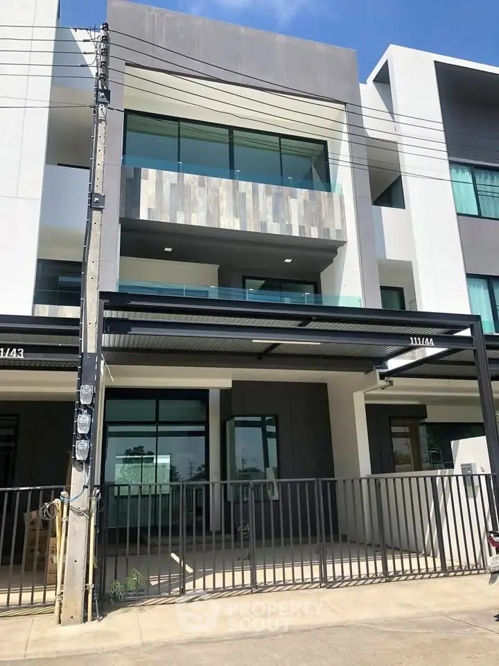 Modern three-story townhouse with sleek design and large windows