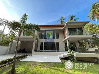 Luxurious modern villa with expansive glass windows, lush greenery, and a spacious outdoor area, perfect for upscale living and entertaining.