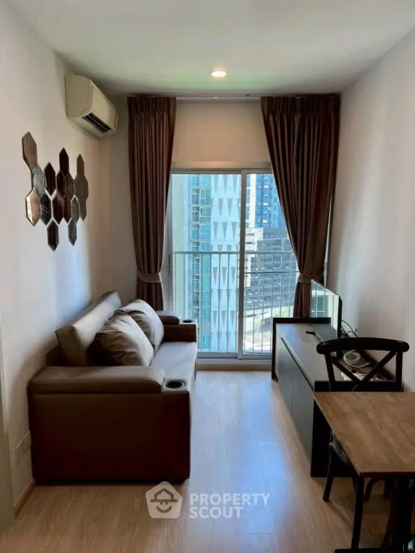 Modern living room with city view, featuring stylish decor and natural light.