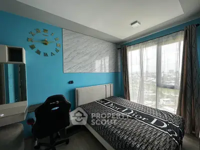 Modern bedroom with city view, stylish decor, and gaming chair