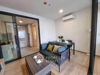 Modern living room with stylish furniture and open kitchen layout in a contemporary apartment.