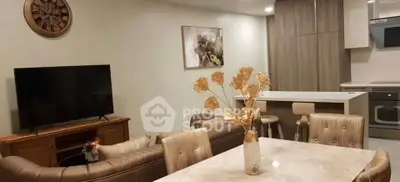 Modern living room with elegant dining area and stylish kitchen in open layout.