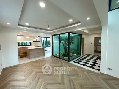 Spacious modern living area with open kitchen and stylish flooring