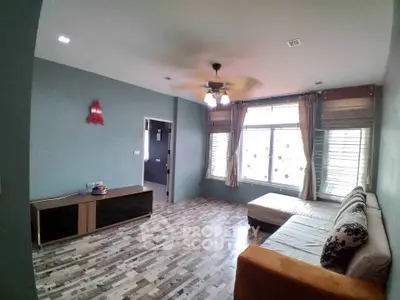 Spacious living room with modern decor and large windows for natural light.