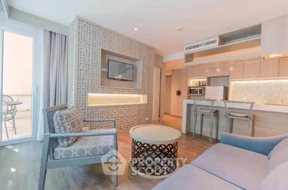 Modern living room with open kitchen and stylish decor in a contemporary apartment.
