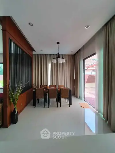 Elegant dining area with modern decor and large windows for natural light