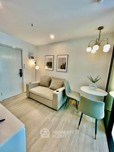 Modern living room with stylish furniture and elegant lighting in a cozy apartment.