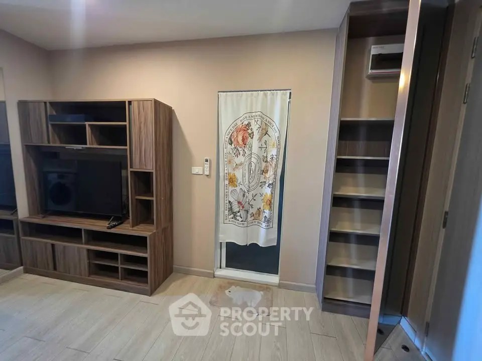 Modern living room with stylish wooden entertainment center and decorative curtain