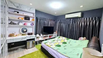 Cozy bedroom with modern decor and entertainment setup
