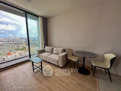 Modern living room with city view, featuring a cozy sofa and stylish dining area.