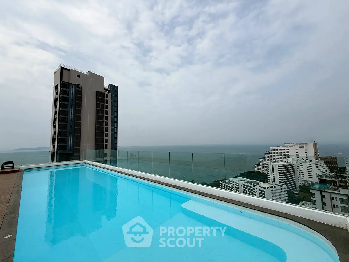 Stunning rooftop pool with breathtaking ocean view and modern high-rise buildings.