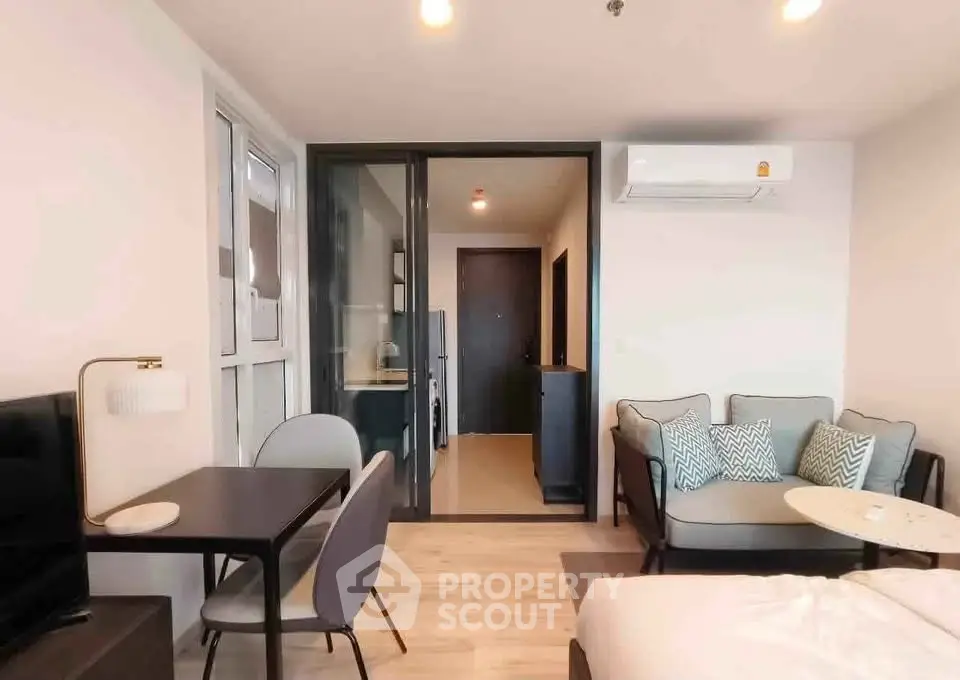 Modern living room with cozy seating and open layout in a stylish apartment.