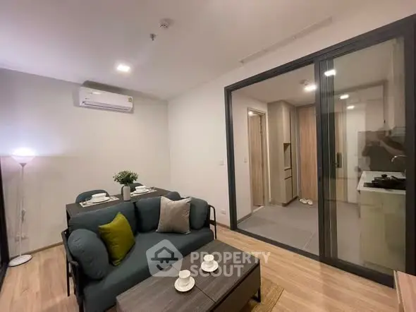 Modern living room with stylish furniture and open kitchen layout