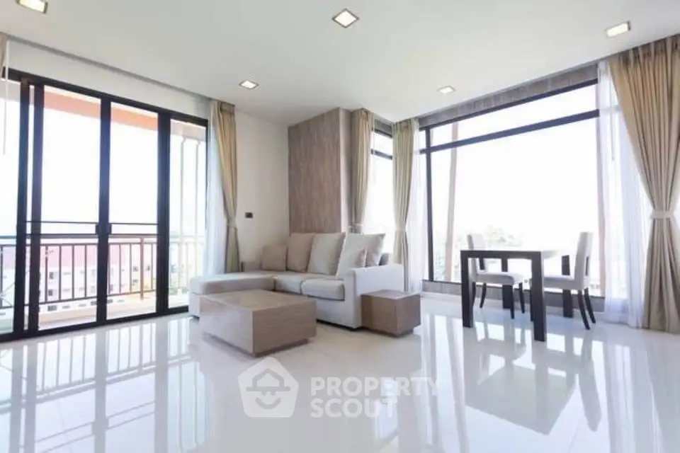 Spacious modern living room with large windows and elegant decor