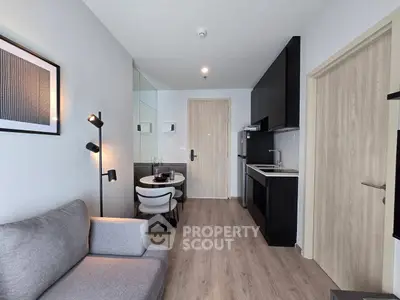 Modern apartment interior with sleek kitchen and cozy living area, perfect for urban living.