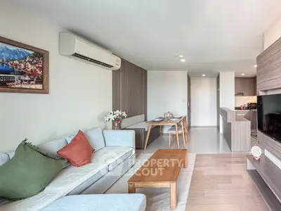 Modern living room with stylish decor and open kitchen layout in a contemporary apartment.