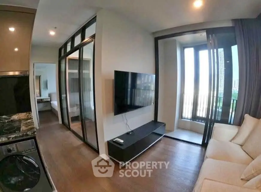 Modern living room with sleek design and large windows in a contemporary apartment.