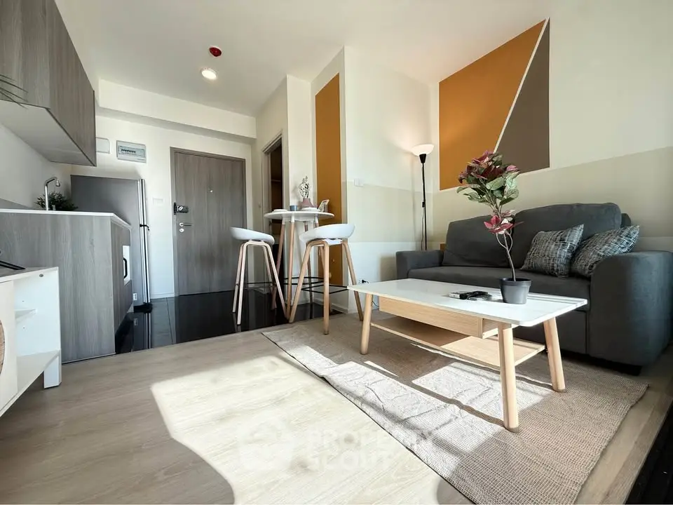 Modern living room with stylish decor and open layout, featuring cozy seating and natural light.