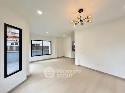 Spacious modern living room with stylish lighting and large windows