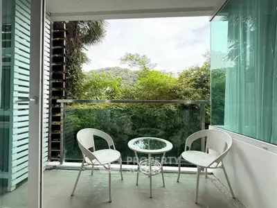 Charming balcony with lush green view, perfect for relaxation and enjoying nature.