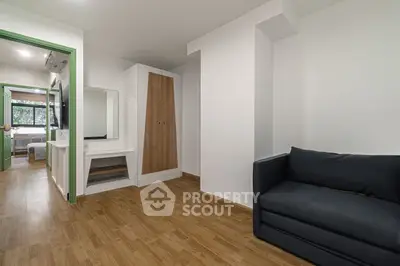 Modern living room with wooden flooring and sleek furniture in a contemporary apartment.