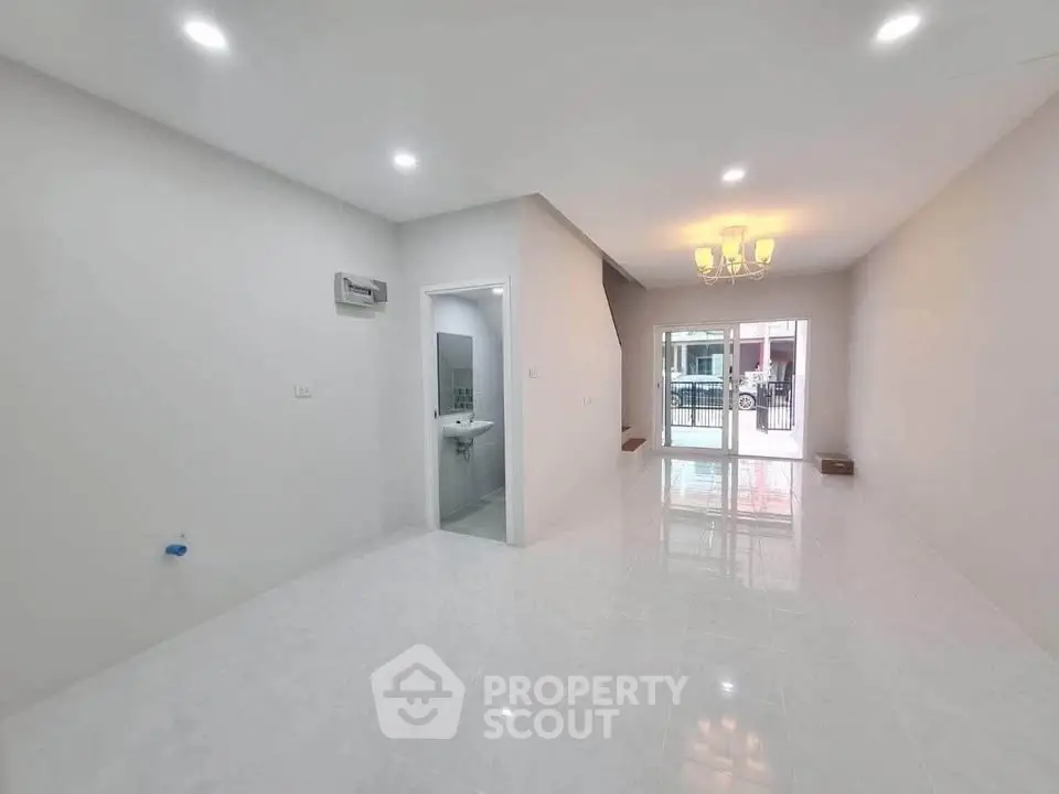 Spacious modern living room with bright lighting and open layout, perfect for family gatherings.