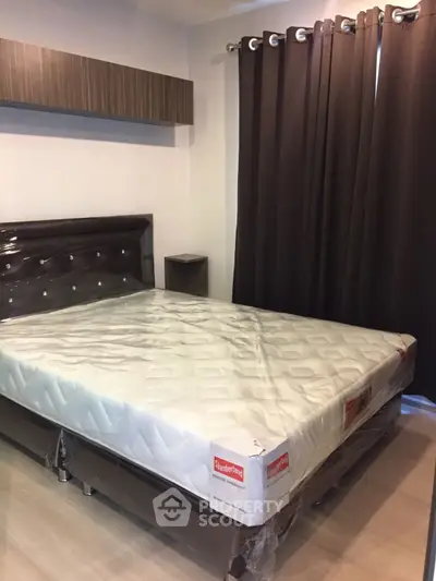Modern bedroom with new mattress and stylish curtains, perfect for cozy living.