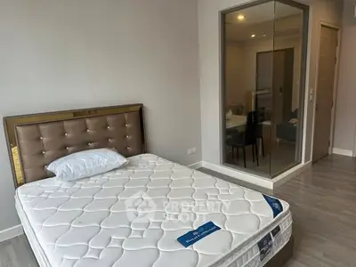 Modern bedroom with stylish bed and glass partition in a contemporary apartment.