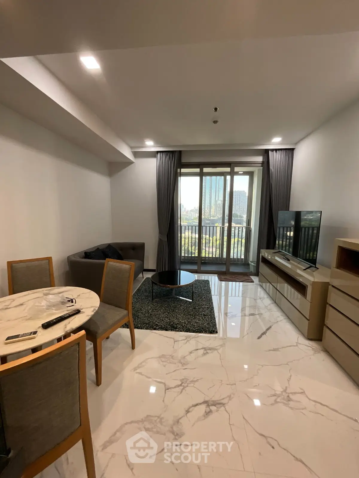 Modern living room with marble flooring and balcony view in a stylish apartment.