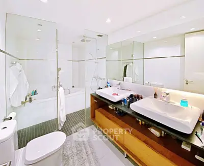 Luxurious modern bathroom with dual sinks and glass-enclosed shower
