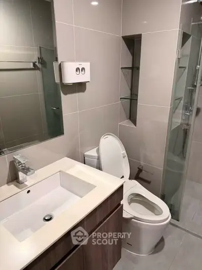 Modern bathroom with sleek fixtures and glass shower enclosure