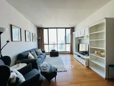 Spacious living room with city view, modern furniture, and natural light.