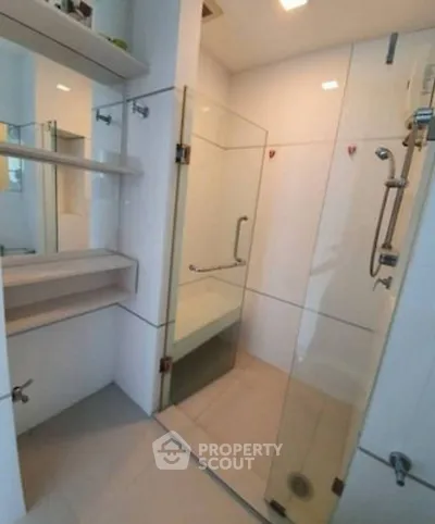Modern bathroom with glass shower enclosure and sleek fixtures